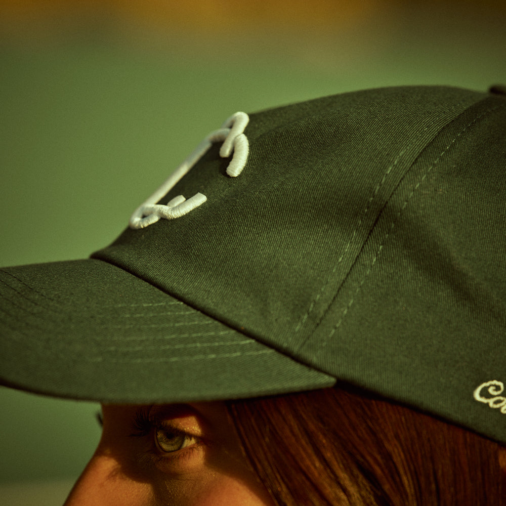 
                      
                        Cap in Dark Green with embroidery
                      
                    